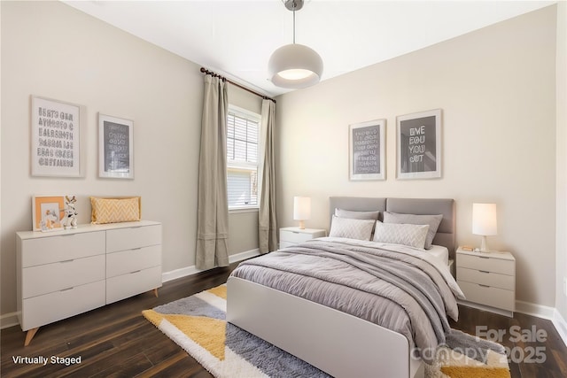 bedroom with baseboards and dark wood finished floors