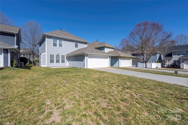 view of front of house featuring a garage, a front yard, driveway, and fence