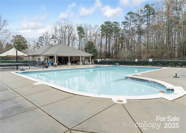 pool featuring fence and a patio