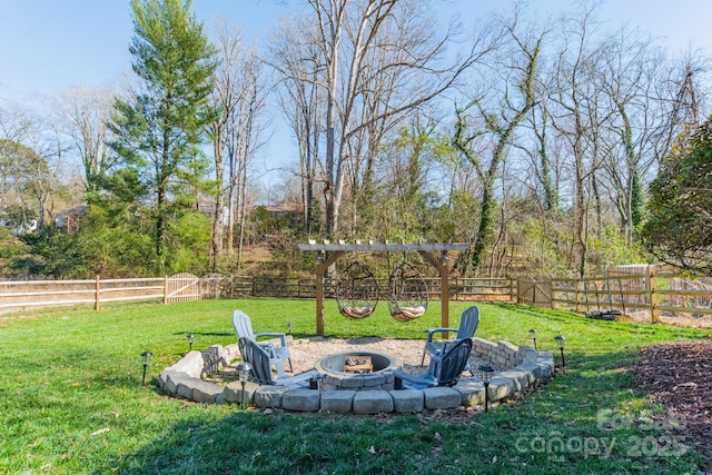 view of yard with a fenced backyard and a fire pit