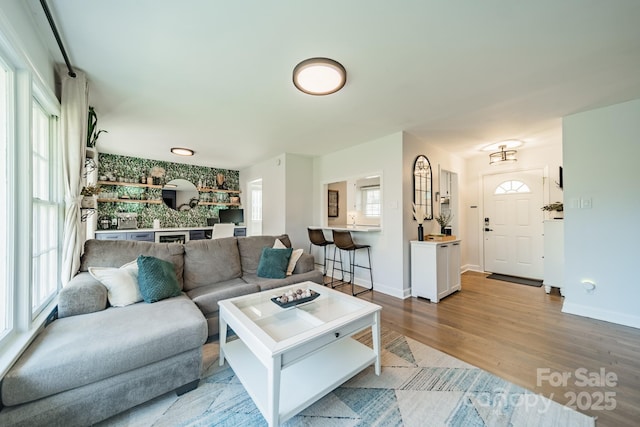 living area with wood finished floors and baseboards