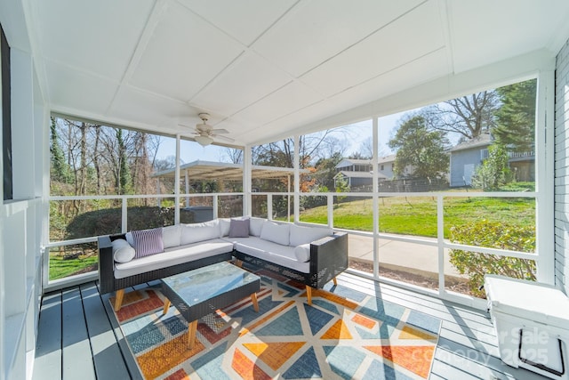 sunroom / solarium with a ceiling fan