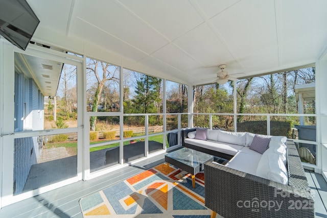 unfurnished sunroom featuring plenty of natural light and a ceiling fan