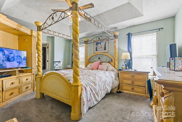 carpeted bedroom featuring a textured ceiling and a ceiling fan