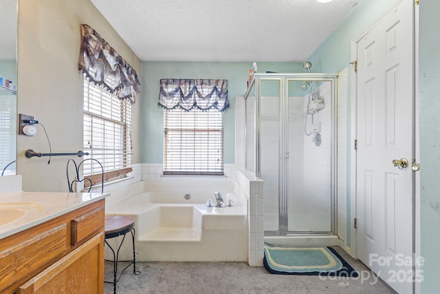 full bath featuring a garden tub, a shower stall, a textured ceiling, and vanity