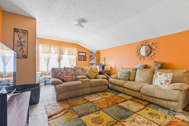 carpeted living room featuring lofted ceiling and a textured ceiling