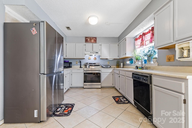 kitchen featuring light tile patterned floors, visible vents, under cabinet range hood, black appliances, and a sink