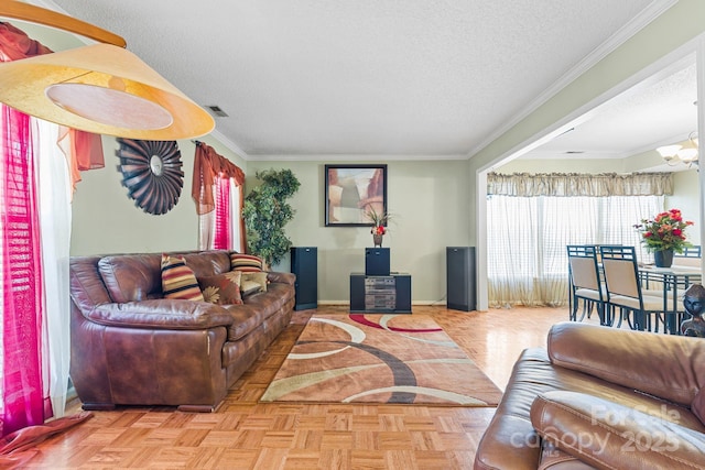 living room with visible vents, an inviting chandelier, ornamental molding, a textured ceiling, and baseboards