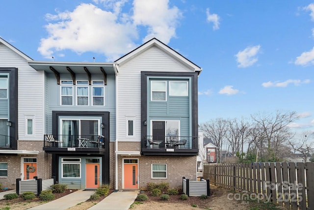 multi unit property with brick siding and fence