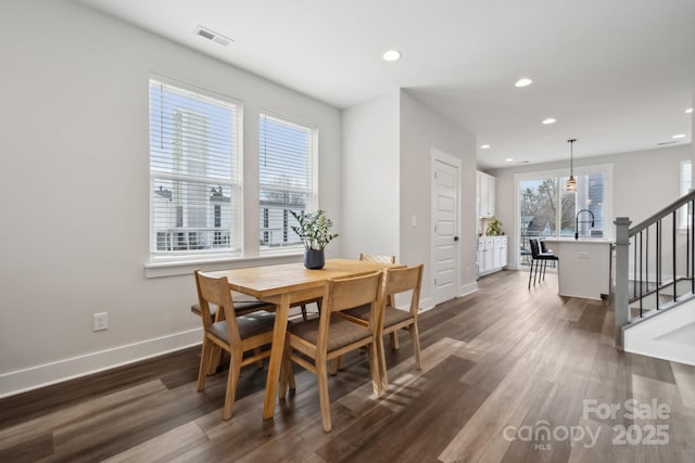 dining room with recessed lighting, dark wood-type flooring, visible vents, baseboards, and stairs