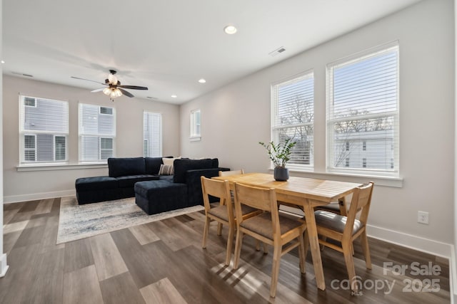 dining room featuring visible vents, a wealth of natural light, and baseboards