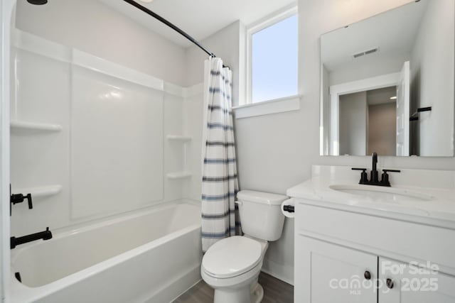 full bath with toilet, wood finished floors, vanity, visible vents, and shower / bathtub combination with curtain