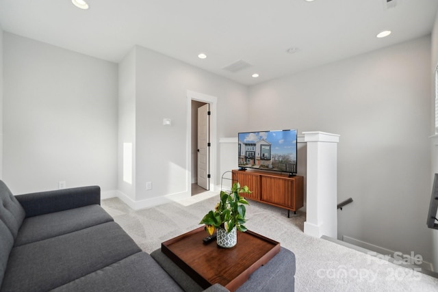 living area with recessed lighting, light colored carpet, and baseboards