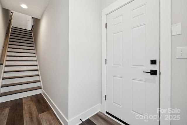 interior space with recessed lighting, dark wood-style flooring, baseboards, and stairs