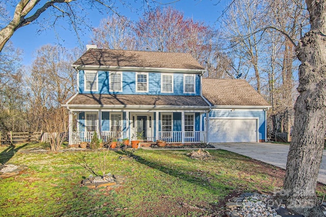 view of front of property featuring covered porch, concrete driveway, fence, a garage, and a front lawn