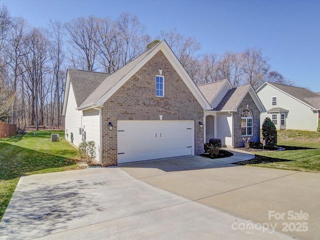 view of front of home with driveway, a garage, a front yard, central AC, and brick siding