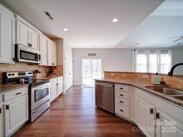 kitchen with plenty of natural light, visible vents, stainless steel appliances, and a sink