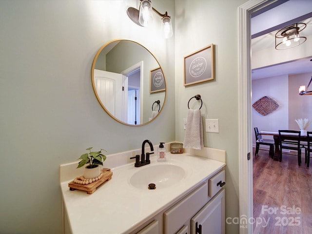 bathroom with vanity and wood finished floors