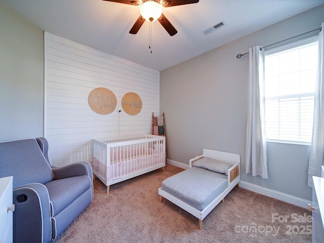 bedroom featuring multiple windows, carpet flooring, visible vents, and baseboards