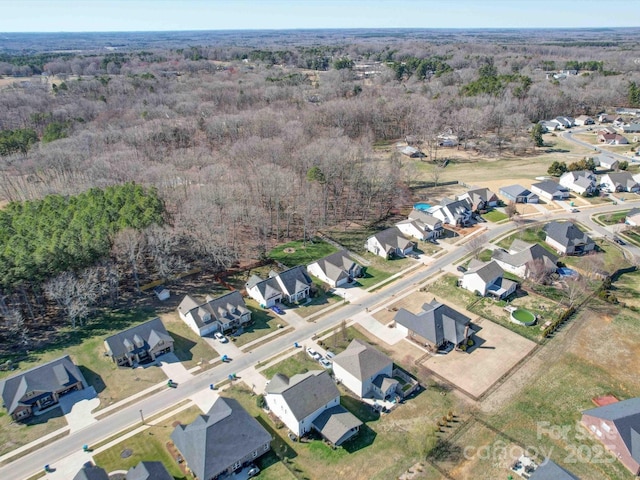 bird's eye view featuring a forest view and a residential view