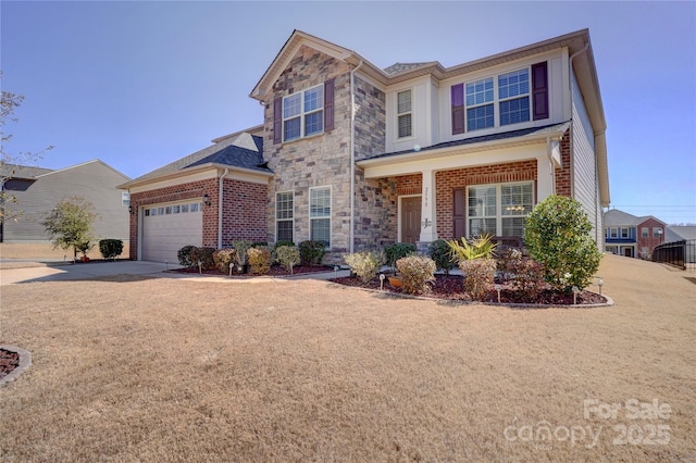 traditional-style home with stone siding, brick siding, driveway, and an attached garage