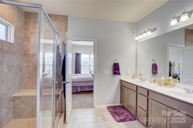 ensuite bathroom with ensuite bathroom, double vanity, a stall shower, and a sink