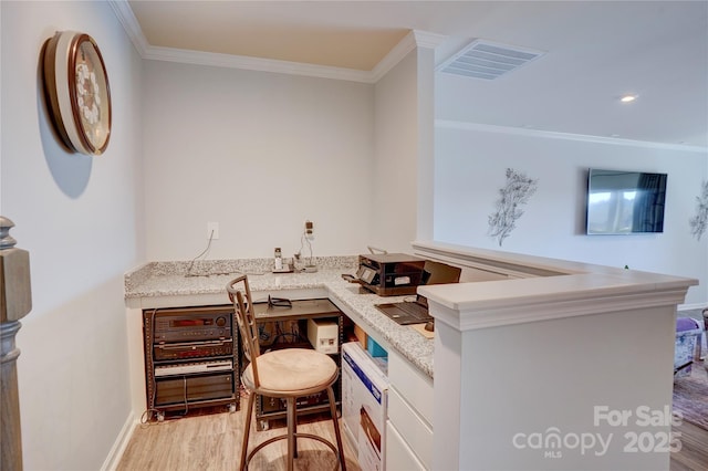 bar with light wood-style floors, visible vents, and crown molding