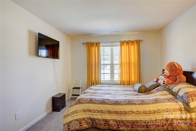 carpeted bedroom featuring visible vents and baseboards