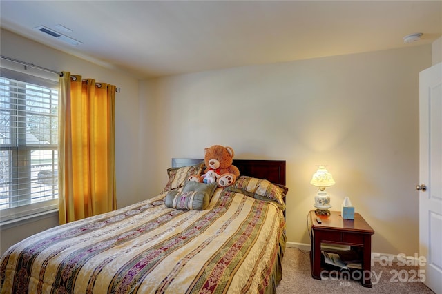 bedroom featuring baseboards, visible vents, and carpet flooring