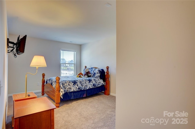 carpeted bedroom featuring baseboards