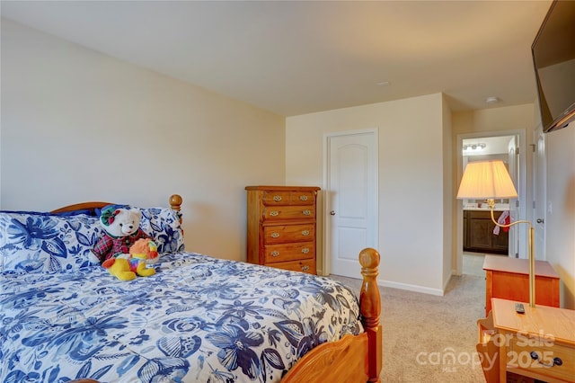 bedroom featuring carpet and baseboards