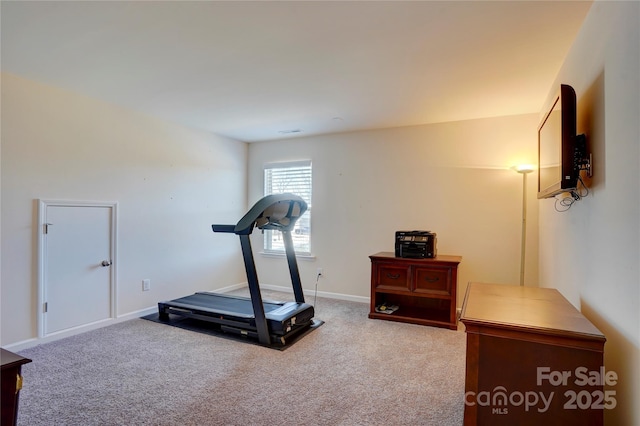 exercise area featuring carpet and baseboards