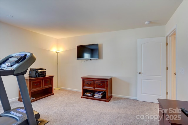 exercise room with carpet floors and baseboards