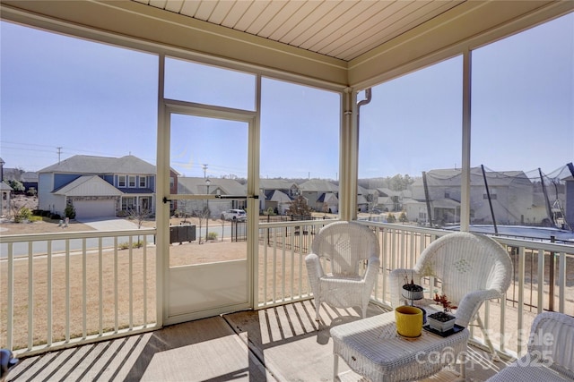 sunroom featuring a residential view