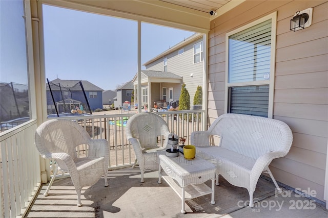 sunroom / solarium featuring a residential view