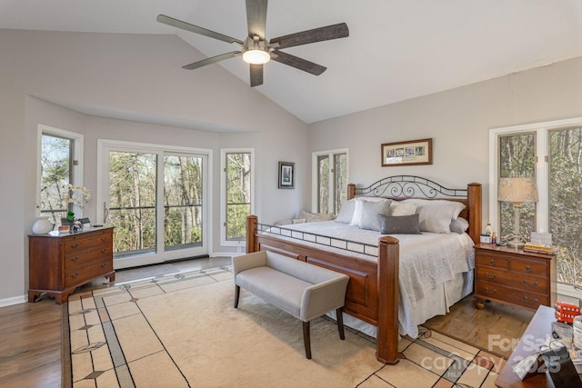 bedroom featuring ceiling fan, light wood-style flooring, high vaulted ceiling, and access to outside