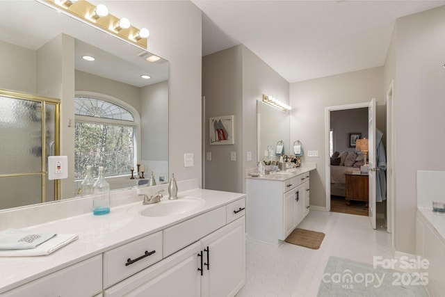 ensuite bathroom with a garden tub, a shower stall, ensuite bathroom, and vanity