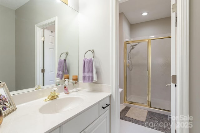 full bathroom featuring recessed lighting, a shower stall, and vanity