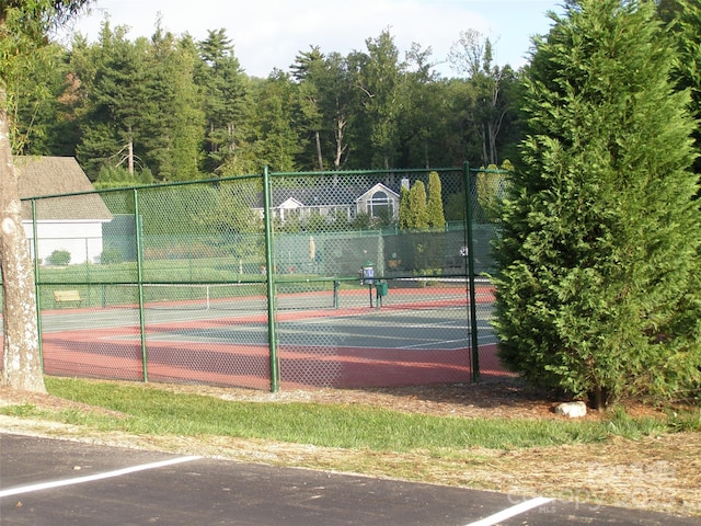 view of sport court featuring fence