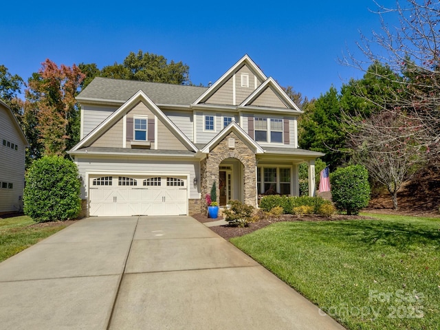 craftsman inspired home featuring stone siding, a front yard, and driveway