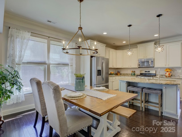 dining space featuring dark wood-style flooring, plenty of natural light, visible vents, and crown molding