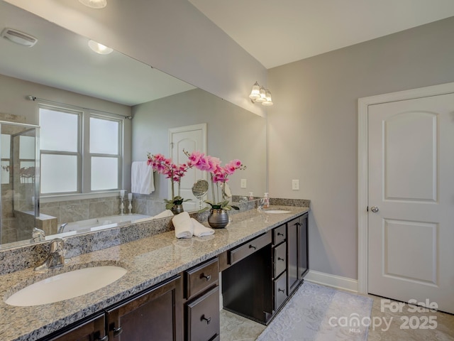 bathroom featuring a sink, visible vents, a shower stall, a bath, and double vanity