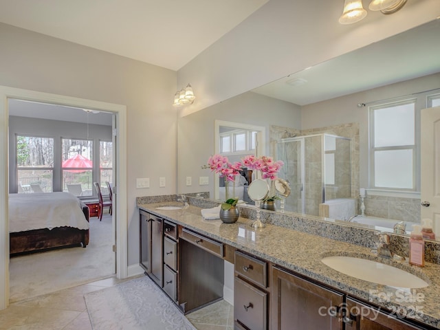 ensuite bathroom featuring a garden tub, double vanity, a stall shower, connected bathroom, and a sink