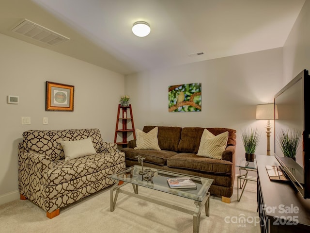 living room featuring visible vents and light colored carpet