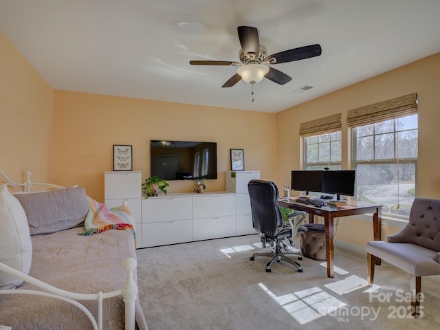 office space with light carpet, ceiling fan, and visible vents