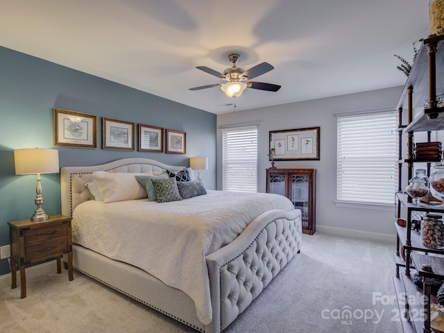 bedroom featuring a ceiling fan, light carpet, and baseboards