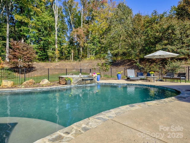 view of swimming pool featuring fence, a fenced in pool, and a patio