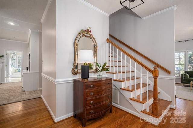 stairway featuring visible vents, baseboards, ornamental molding, recessed lighting, and wood finished floors