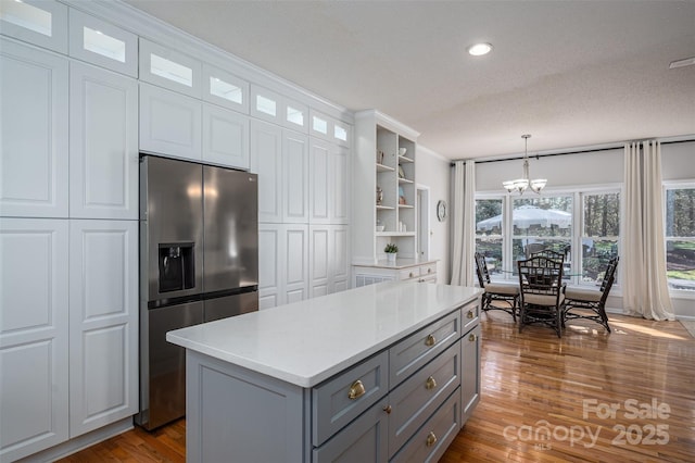 kitchen with gray cabinets, stainless steel refrigerator with ice dispenser, open shelves, white cabinetry, and light countertops