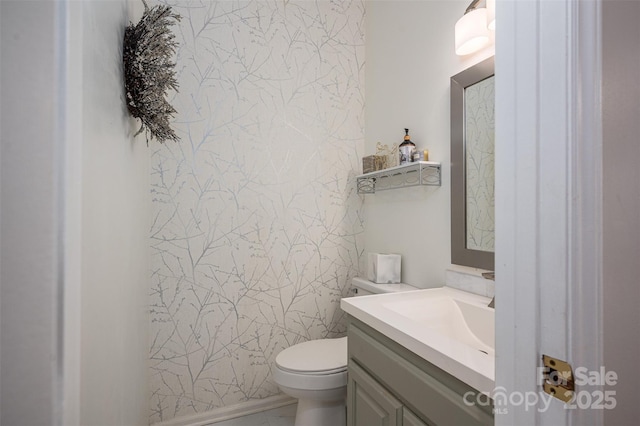 bathroom featuring toilet and vanity